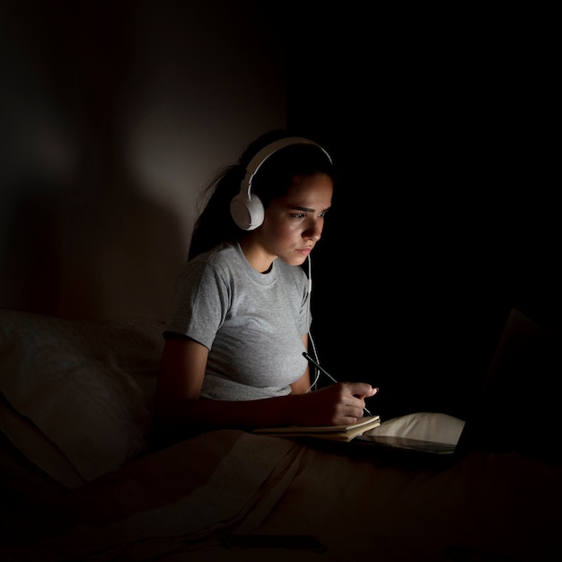 Side view of woman working late at home