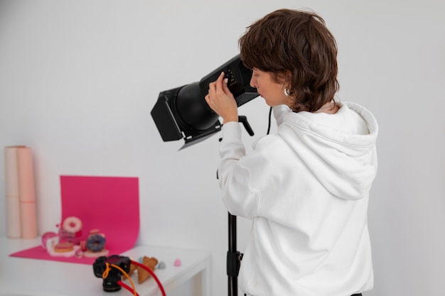 Side view woman working in photography studio