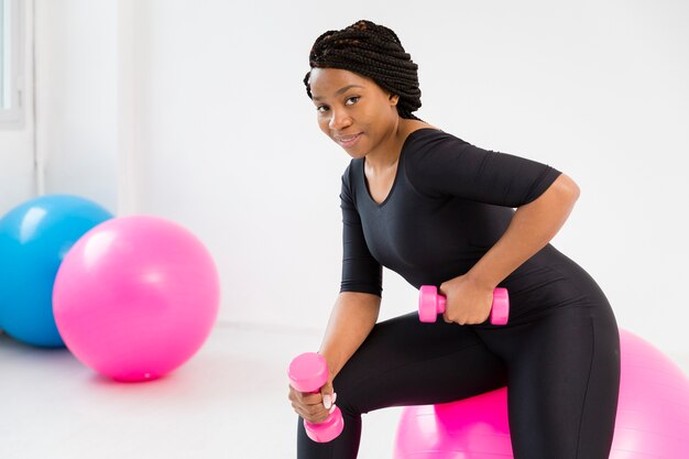 Side view woman working with hand weights