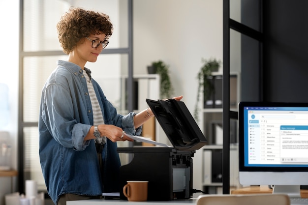 Side view woman working with printer