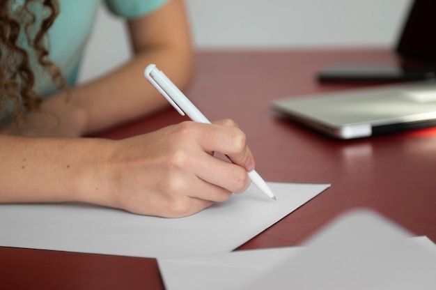 Free photo side view woman writing letter