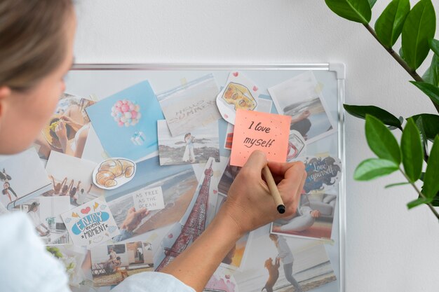 Side view woman writing on post it