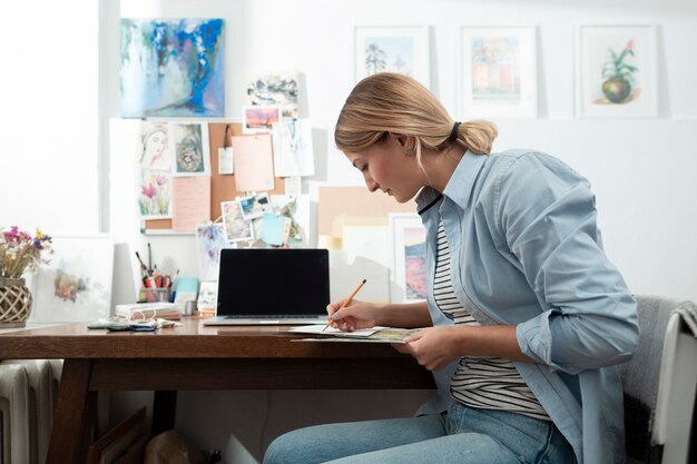 Side view of woman writing