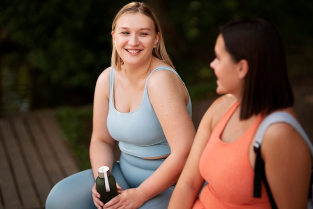 Side view women chatting outdoors