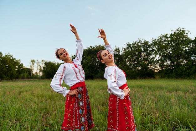 Free photo side view women dancing together