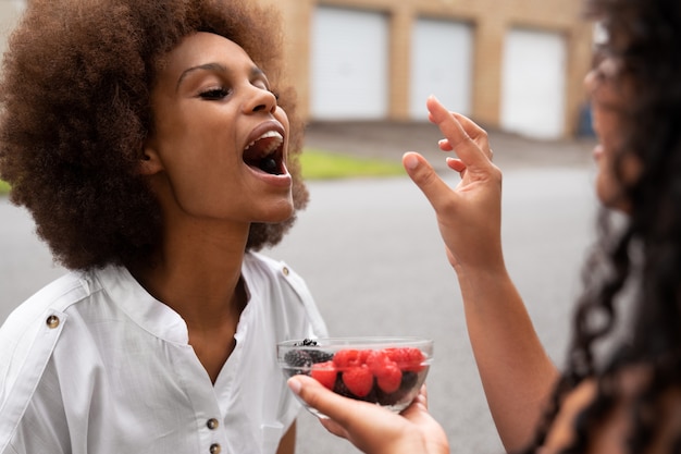 Side view women eating berries