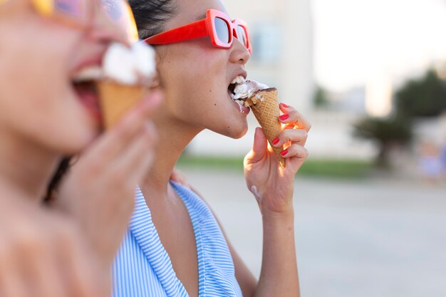 Side view women eating ice cream