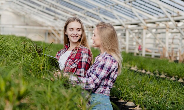 Side view women in greenhouse