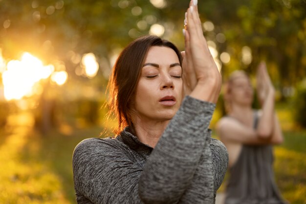 Side view women meditating in nature