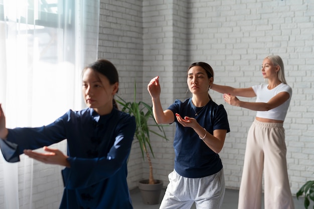 Side view women practising tai chi