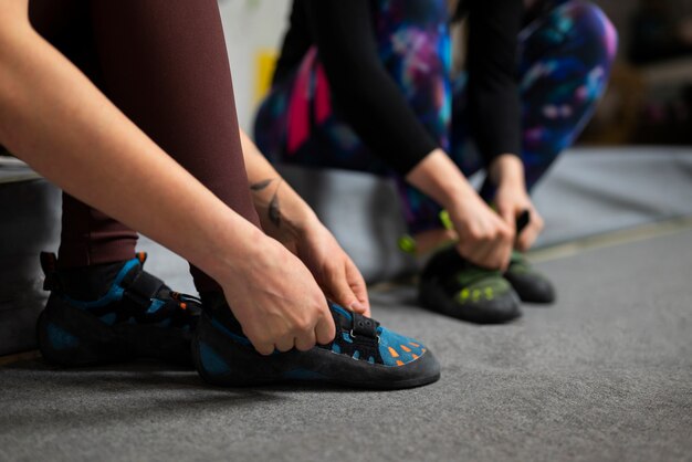 Free photo side view women putting on shoes