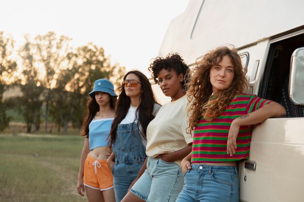 Side view women standing near campervan