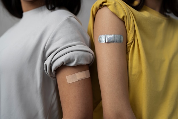 Side view women wearing band aids