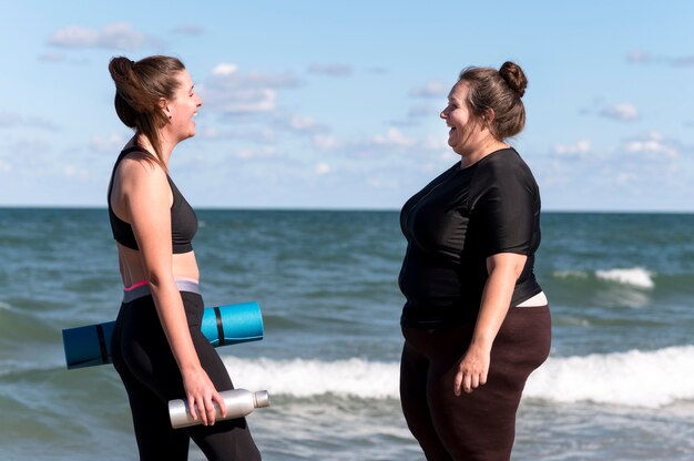 Side view women with yoga mat