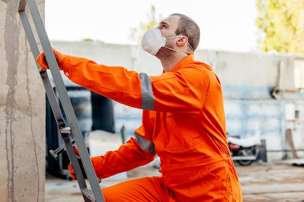 Side view of worker in uniform with protective mask