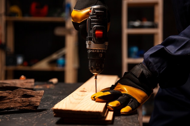 Side view worker using drill