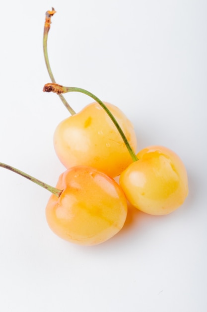 Side view of yellow ripe cherry isolated on white
