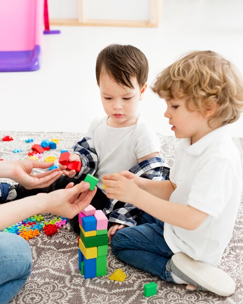 Side view of young boys playing with toys