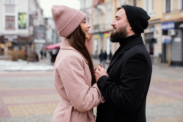 side view young couple outdoor hugging