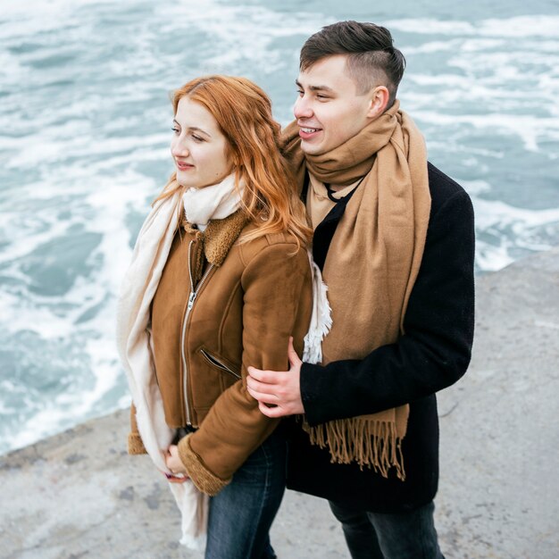 Side view of young couple in winter outside