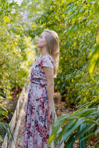 Side view young female posing in foliage center