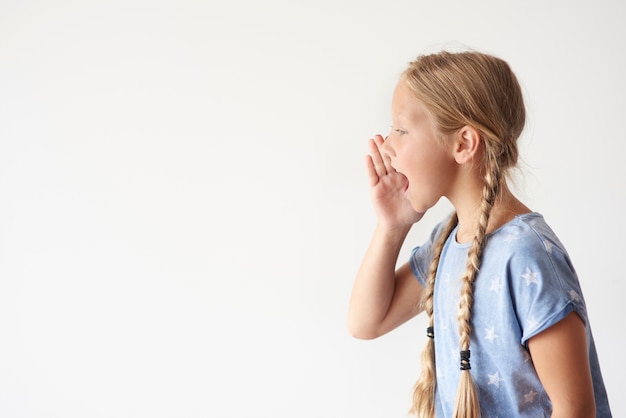 Side view of young girl shouting