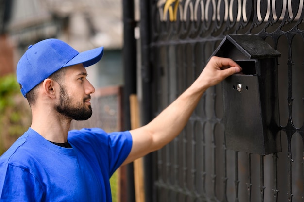 Side view young man delivering mail