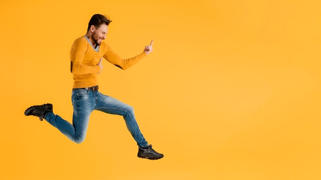 Free photo side view young man jumping