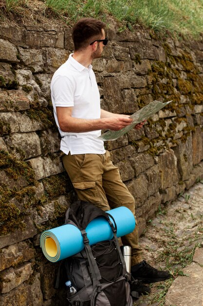 Side view young man reading map