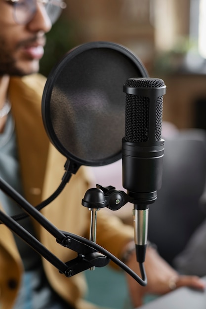 Side view young man recording podcast