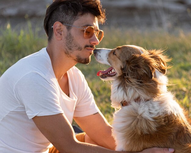 Side view young man with dog at seaside