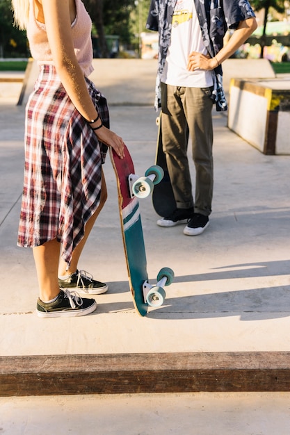 Side view of young skater couple