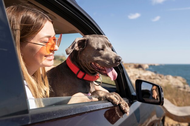 Side view young woman and dog going on a trip