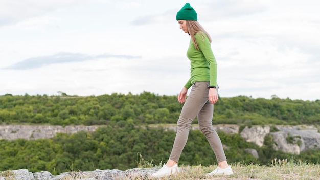 Side view young woman enjoying walking outdoors