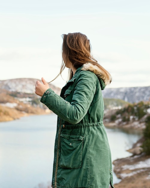 Free photo side view young woman in nature