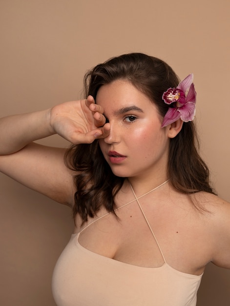 Side view young woman posing with flower