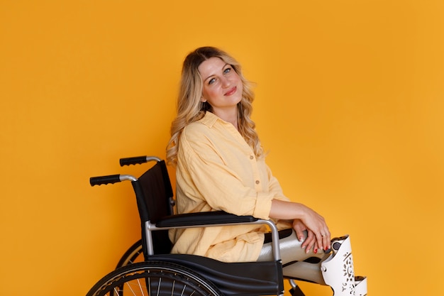 Free photo side view young woman in wheelchair
