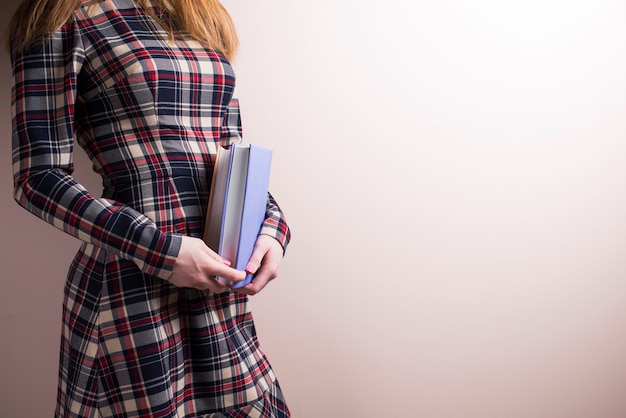 Side view of young woman with books