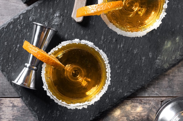 Sidecar cocktail with a sugar rim on wooden table