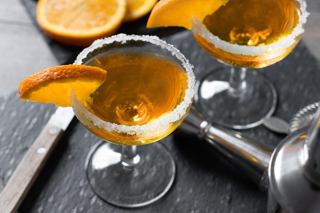 Free photo sidecar cocktail with a sugar rim on wooden table