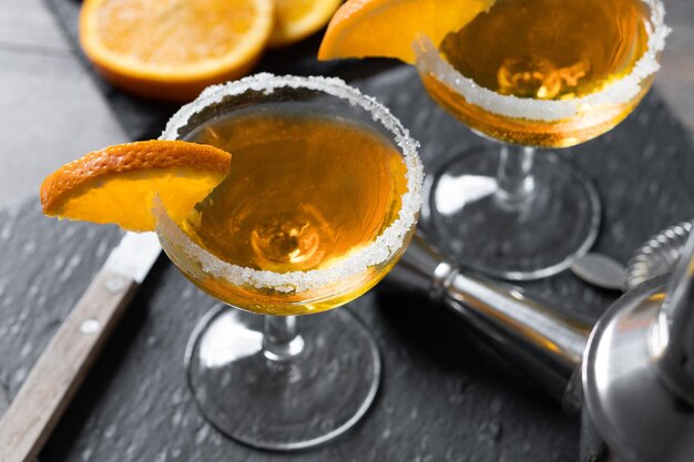 Sidecar cocktail with a sugar rim on wooden table