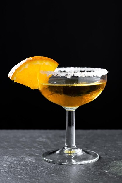 Sidecar cocktail with a sugar rim on wooden table