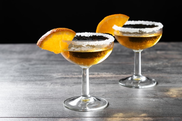 Free photo sidecar cocktail with a sugar rim on wooden table