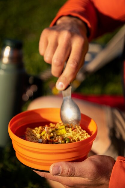 Sided view man holding bowl and spoon