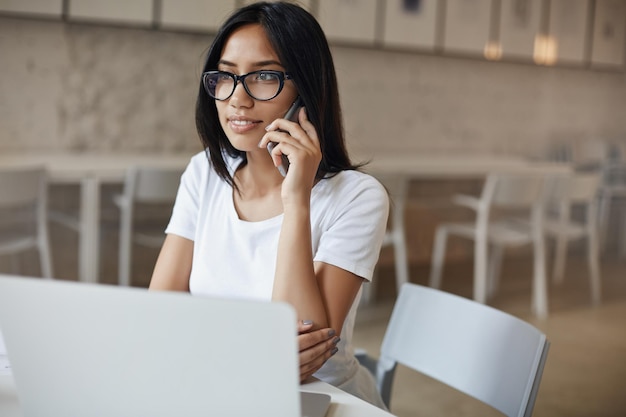 Sideshot busy confident young empowered woman in glasses sit al