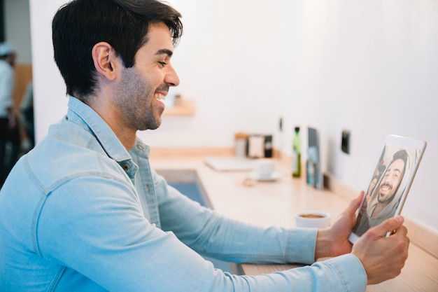 Sideview of man looking photos on tablet