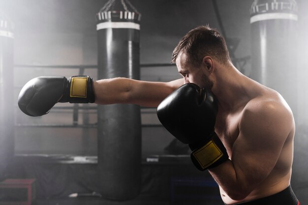Sideways boxer with black gloves training