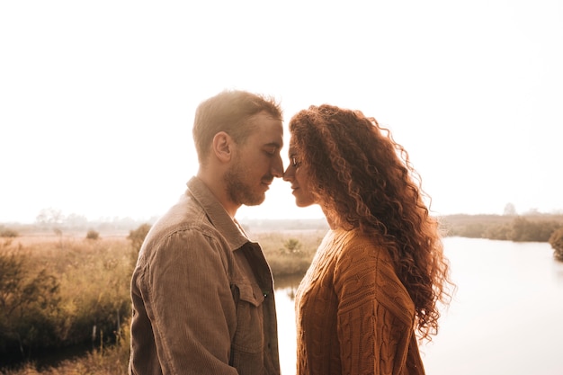 Free photo sideways happy couple having a tenderness moment