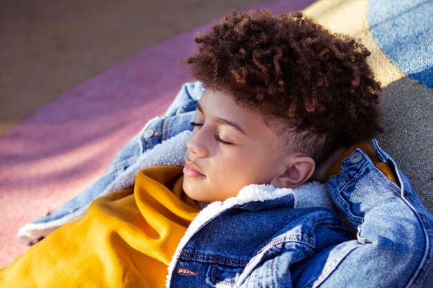 Sideways little boy relaxing at the playground