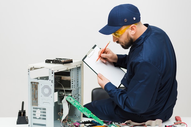 Sideways man repairing a computer